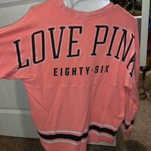Orange colored, medium in size, PINK shirt.